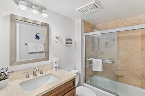 a bathroom with a sink and a shower at Kamaole Sands 1101 · KAS 1101 Updated Beachy Chic 2BD Across Bea in Wailea