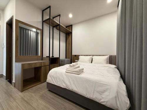 a bedroom with a large bed and a sink at Town House for rent in Thủ Đức in Ho Chi Minh City