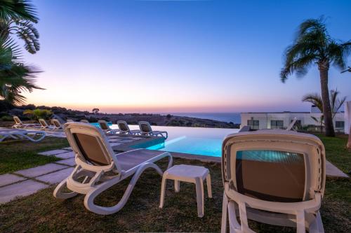 a group of chairs and a tv next to a pool at Le Tanger Résidence Hôtelière in Tangier