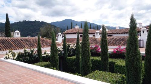 a garden in front of a building with trees and flowers at San Rafael Hotel in Antigua Guatemala