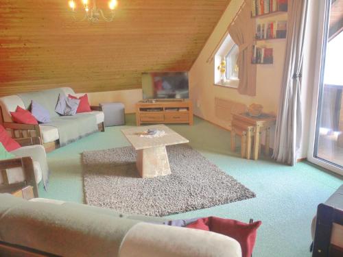 a living room with a couch and a table at Wohl eingerichtete Wohnung mit eigenem Balkon in Sankt Michael im Lungau