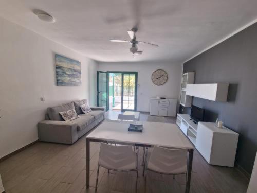a living room with a table and a couch at Casa Real in Playa Blanca