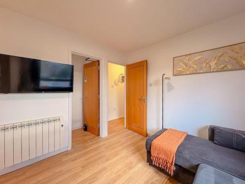 a room with a bed and a flat screen tv at Russet Grove in Earlham
