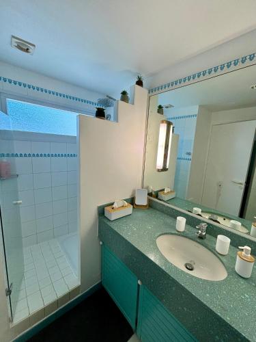 a bathroom with a sink and a shower at Studio Carayou Pointe du Bout Les Trois-Ilets in Les Trois-Îlets