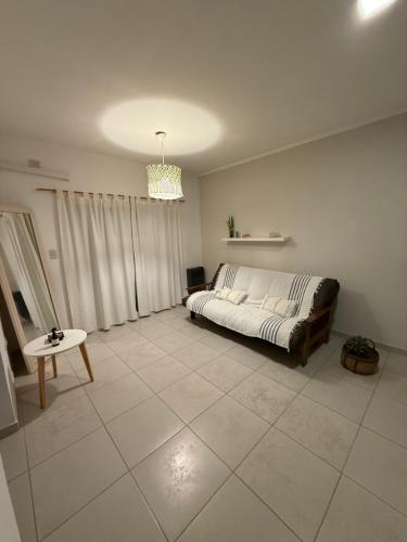 a bedroom with a bed sitting on a tiled floor at Departamento en Esperanza in Esperanza