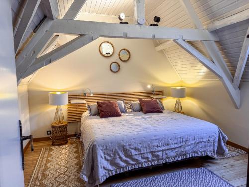 a bedroom with a bed and two clocks on the wall at Skindles Guesthouse in Poperinge