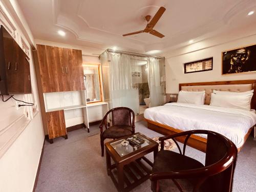 A television and/or entertainment centre at Quiet Edge Resort A Luxury Room With Balcony By Anvi Retreat