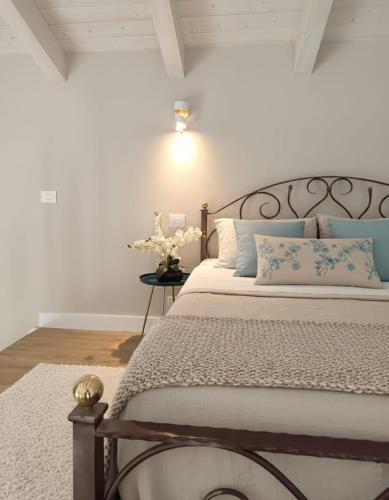 a bedroom with a bed with blue and white pillows at La Casa di Stefania LOFT in Pollutri