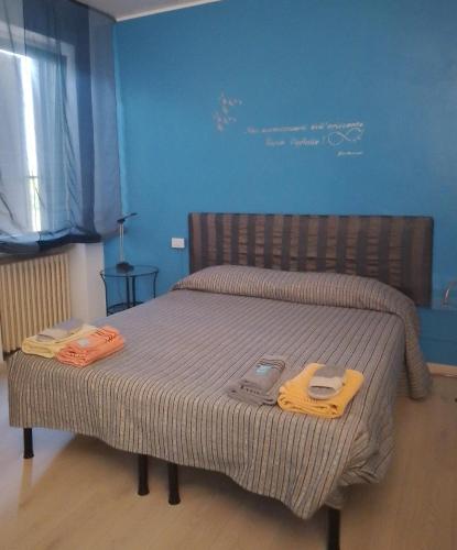 a bedroom with a bed with two slippers on it at Al 54 in San Giorgio Di Mantova