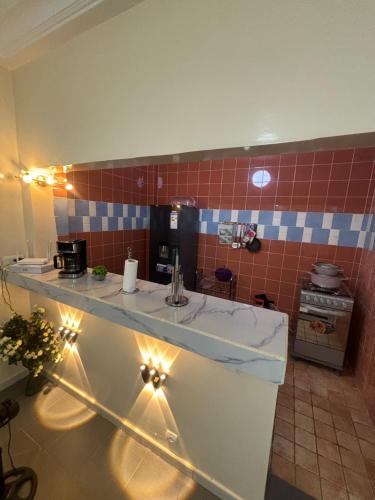 een badkamer met een aanrecht met een wastafel en verlichting bij Residence FATIMA thies in Thiès