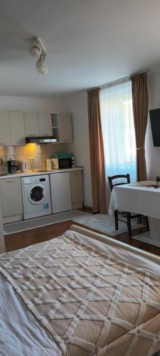 a room with a kitchen and a living room with a table at Studio O&A in Cristian