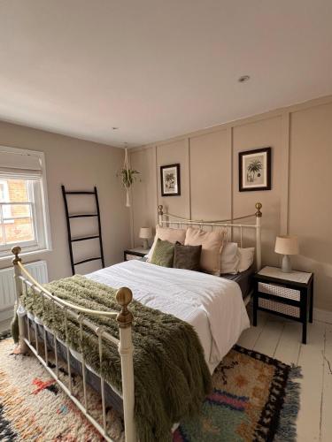 a bedroom with a large bed and a window at Two Bedroom House in the Heart of Winchester in Winchester