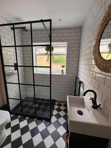 a bathroom with a sink and a mirror at Two Bedroom House in the Heart of Winchester in Winchester