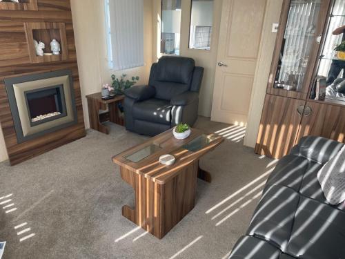 a living room with a couch and a coffee table at Large family holiday home in Gunton