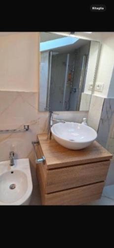 a bathroom with a white sink and a mirror at Brera home suite in Milan