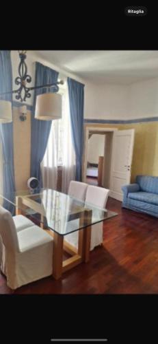 a living room with a glass table and white chairs at Brera home suite in Milan