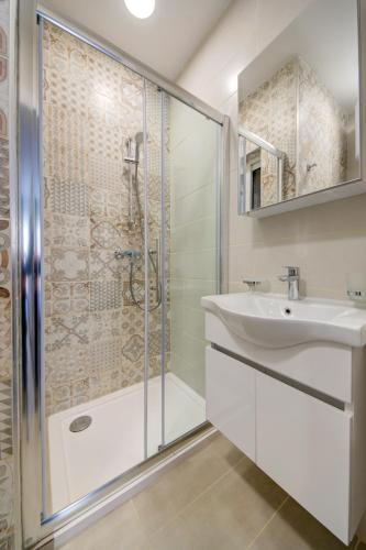 a bathroom with a shower and a sink at Dar One - Self catering & self check in apartments by Tritoni Hotels in Il-Gżira