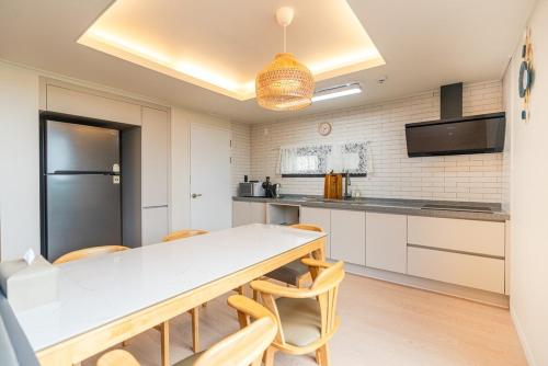 a kitchen with a table and chairs in a room at In Aewol Forest 102 in Haean