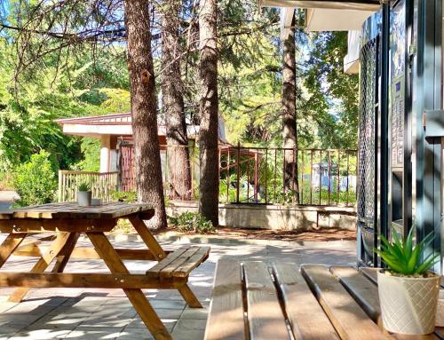 a wooden picnic table and bench on a patio at Студия за нощувки - Стара Загора in Stara Zagora