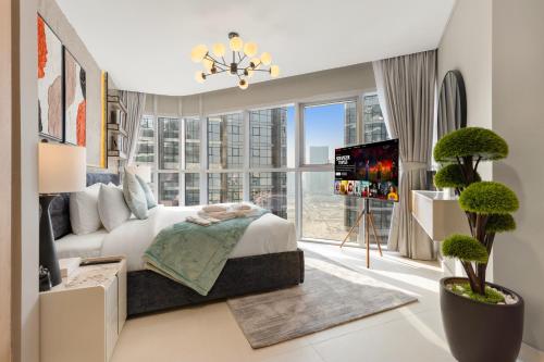 a bedroom with a bed and a large window at Desert Key Apartments - Al Reem Island in Abu Dhabi