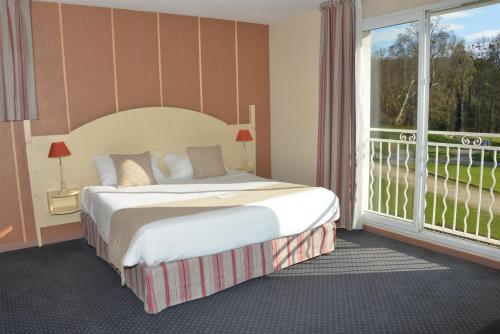 a hotel room with a bed and a large window at Best Western Golf d'Albon in Albon