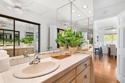 a bathroom with a sink and a large mirror at Kaanapali Plantation 10 · KPL 10 Panoramic Ocean Views 2BD near in Lahaina