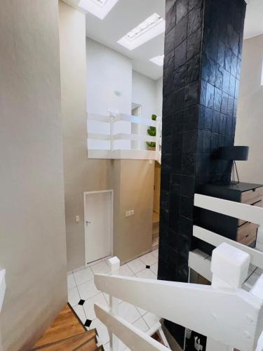 a room with a staircase with black tiles at Olives by Agnes 31 in Hartbeespoort
