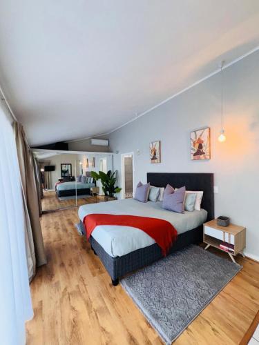 a bedroom with a large bed with a red blanket at Olives by Agnes 31 in Hartbeespoort