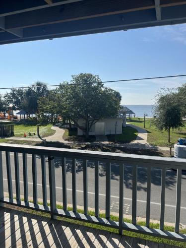 a balcony with a view of a road and the ocean at Unit 225 Beautiful Cedar key in Cedar Key