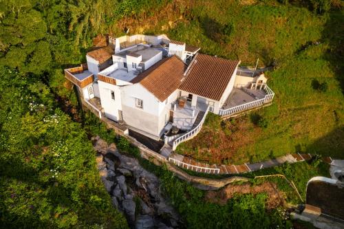 an aerial view of a large house on a cliff at Casa Sol Nascente in Ponta Delgada