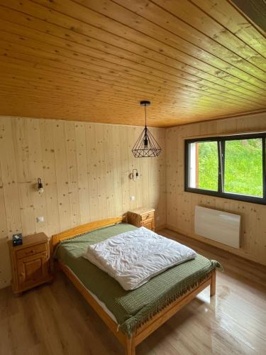 a bedroom with a bed in a wooden room at Appartement EDELWEISS in Châtel