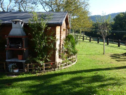 a small house with a garden in a field at Casa Rural Urkulu Landetxea in Aretxabaleta