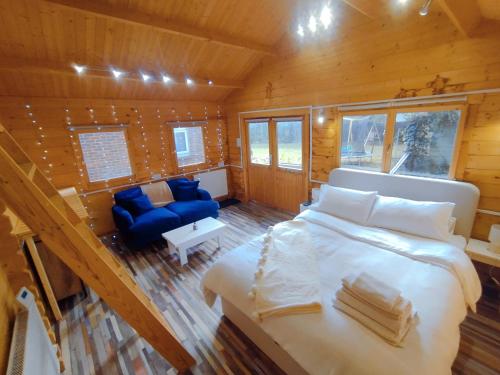 a bedroom with a large bed in a wooden cabin at White Cliff Rest in Seaford
