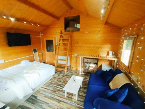 a bedroom with a bed and a couch and a fireplace at White Cliff Rest in Seaford