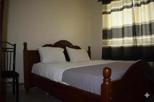 Postel nebo postele na pokoji v ubytování Jambo Guest House