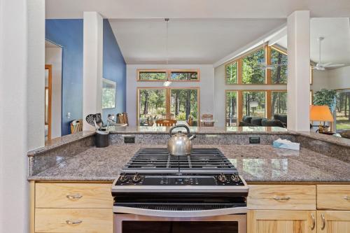 a kitchen with a stove and a tea kettle at 1 Colonial in Sunriver