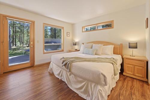 a bedroom with a large bed and a window at 1 Colonial in Sunriver