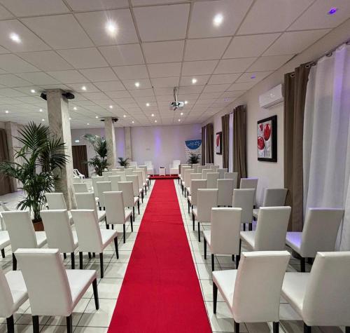 a room with white chairs and a red carpet at Mg Palace Hotel Costa del Sole in Vaccarizzo - Delfino