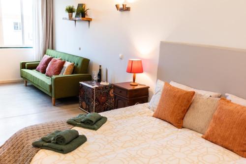 a bedroom with a bed with two towels on it at Seaview Ensuite rooms in Sagres centre - Casa Maluka in Sagres