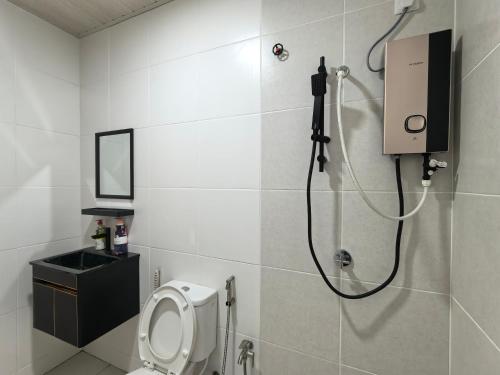 a bathroom with a shower and a toilet in it at D Aman Infinity Pool and AS Tower View Homestay 05 in Alor Setar