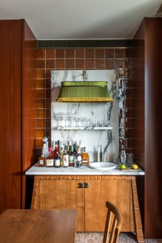 a kitchen with a sink and a wooden cabinet at Brach Madrid - Evok Collection in Madrid