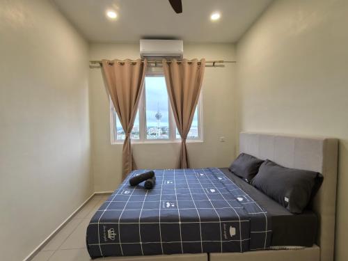 a bedroom with a bed with a teddy bear on it at D Aman Infinity Pool and AS Tower View Homestay 05 in Alor Setar