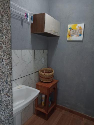 a small bathroom with a sink and a toilet at Sítio Doce Mel in Saquarema
