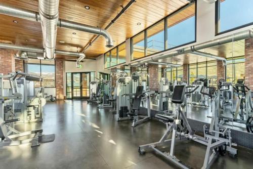 a gym with treadmills and elliptical machines at 1min Delta - Salt Palace - King Bed - Gym - Parking in Salt Lake City