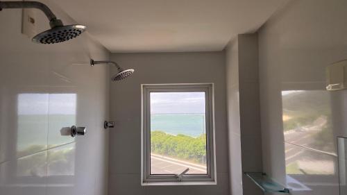 a bathroom with a shower and a window at Reserva Praia Hotel in Balneário Camboriú