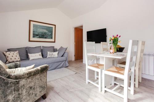 a living room with a couch and a table at Willow Cottage in Ryde