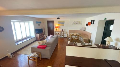 a living room with a couch and a table at CASA da LINHA in Caminha