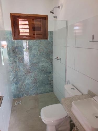 a bathroom with a toilet and a sink and a shower at Pousada Janela dos Ventos in Caucaia