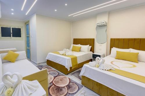 a room with two beds with towels on them at Star Vysta pyramids hotel in Cairo