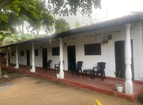 a group of chairs sitting outside of a building at accomodation katunayaka in Negombo